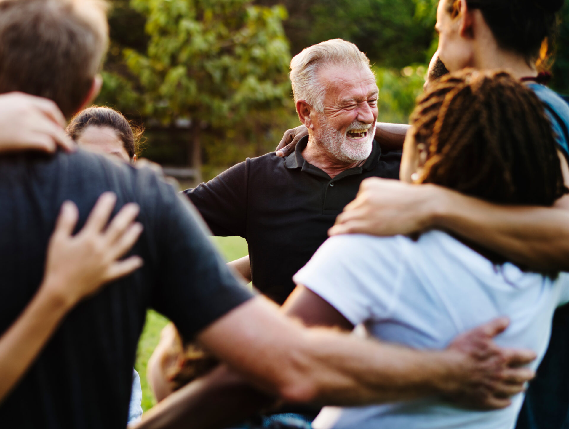 a group of people smiling and hugging